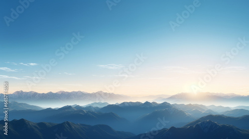 A mountain range, with peaks of various heights and shapes, looms on the horizon The sky is a brilliant, clear blue, and the sun is setting in the distance © Textures & Patterns