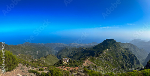 Embark on a journey along the trail leading to Pico Ruivo summit on Madeira Island. Experience the beauty of surrounding mountains and catch a glimpse of the trail itself