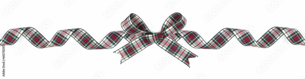 Green, red and white plaid Christmas gift bow and ribbon. Long border, curled, isolated on a white background. Green, red and white plaid Christmas gift bow and ribbon. Long border, curled, isolated on a white background.
