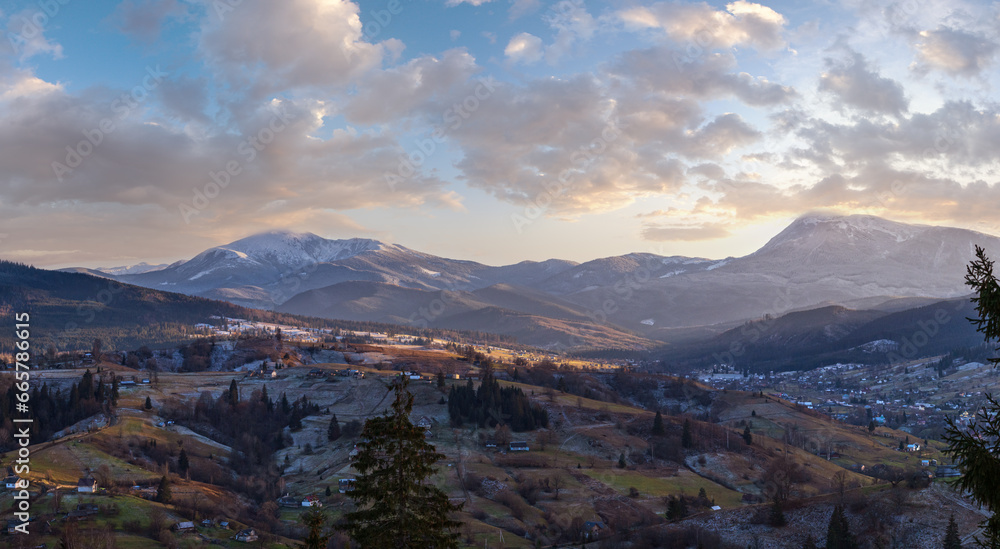 Late autumn mountain pre sunset scene with snow covered tops in far. Picturesque traveling, seasonal, nature and countryside beauty concept scene. Carpathians, Ukraine. Late autumn mountain pre sunset scene with snow covered tops in far. Picturesque traveling, seasonal, nature and countryside beauty concept scene. Carpathians, Ukraine.