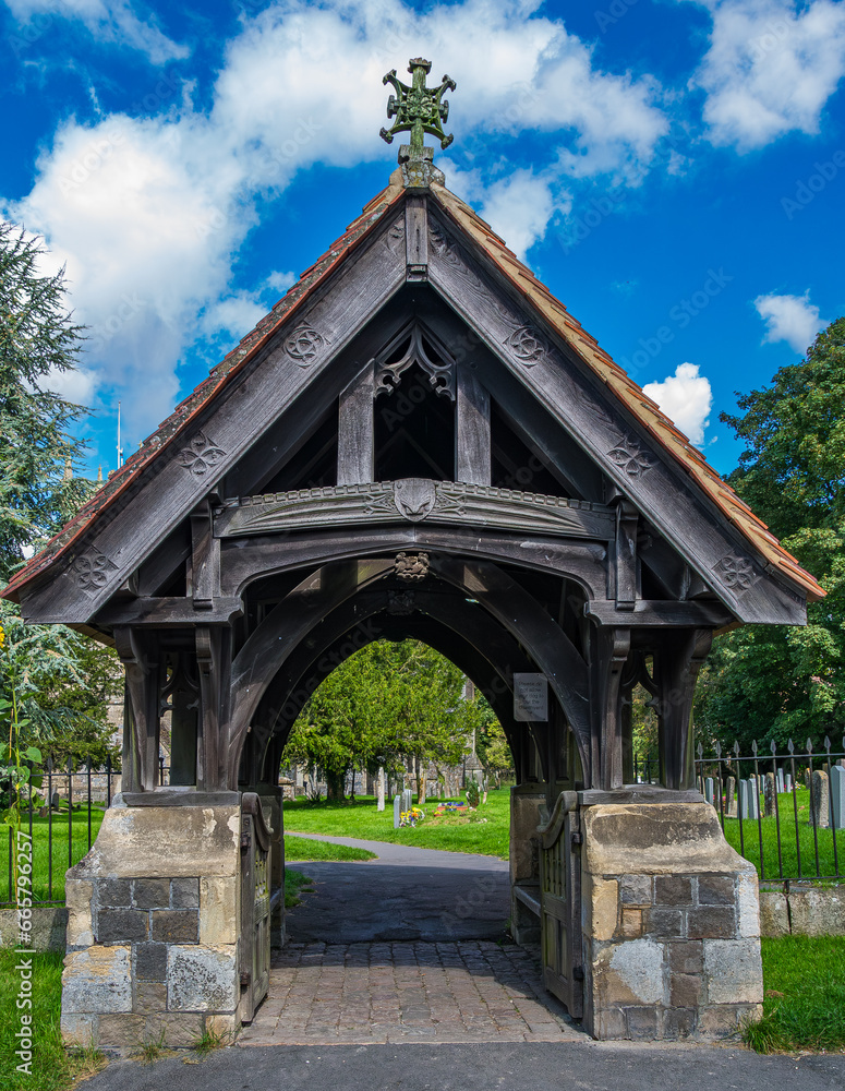 The very old wooden and stone entrance structure to a graveyard in Avebury