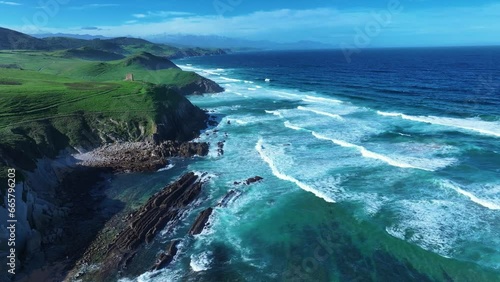 Coastal landscape with waves around El Sable beach in the town of Tagle. Aerial view from a drone. Suances Municipality. Cantabrian Sea. Cantabria. Spain. Europe photo