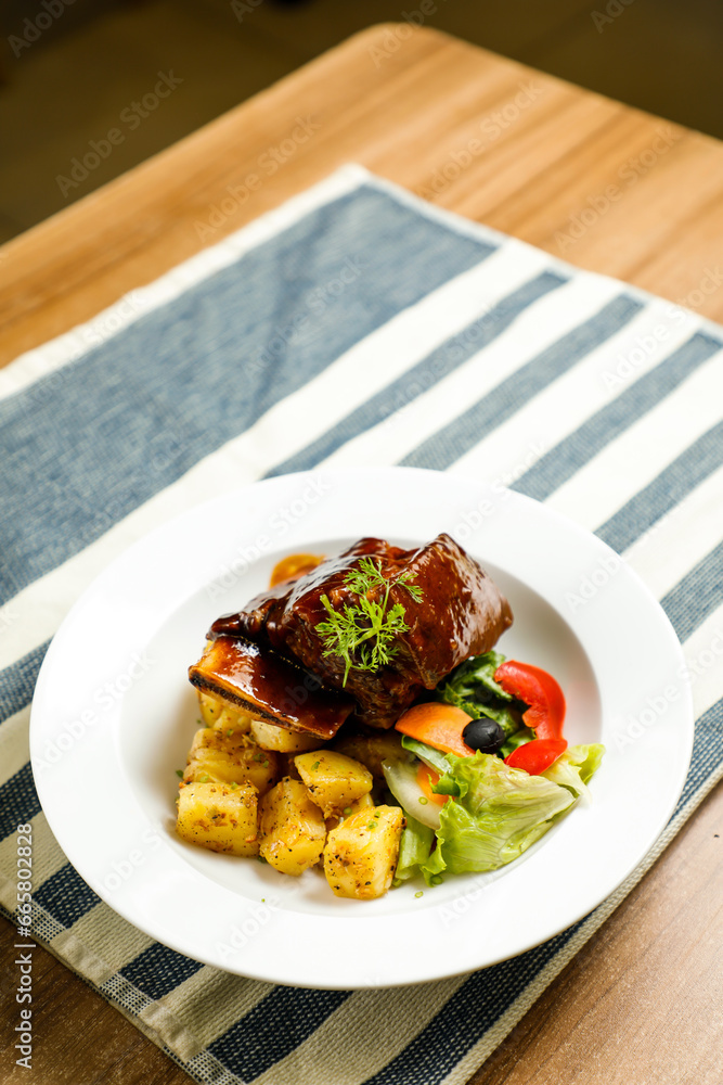 Beef Short Ribs served in plate isolated on napkin side view of korean style meat food Beef Short Ribs served in plate isolated on napkin side view of korean style meat food