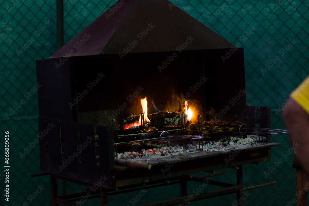 Fire starting in barbeque at summer evening