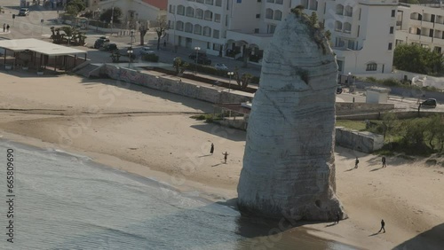 Huge monolith on the beach in Vieste, Italy. Pizzomunno rock standing on the beach. photo