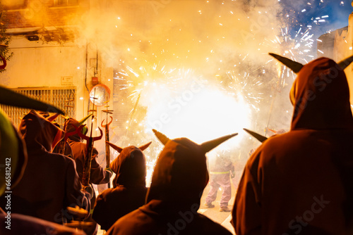 Diables con fuegos artificiales en la calle en fiestas mayores