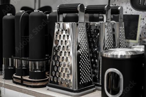 Dishes in the kitchen. Vegetable grater with pepper shaker. Kitchenware. photo