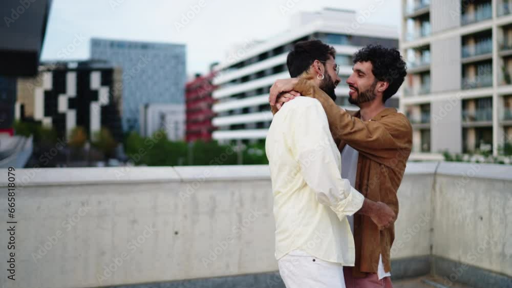 Two gay sweethearts joyfully dance hand in hand, truly living in present and basking in contagious allure of their shared happiness. LGBT male couple hug and kiss during romantic dating. Slow motion Two gay sweethearts joyfully dance hand in hand, truly living in present and basking in contagious allure of their shared happiness. LGBT male couple hug and kiss during romantic dating. Slow motion