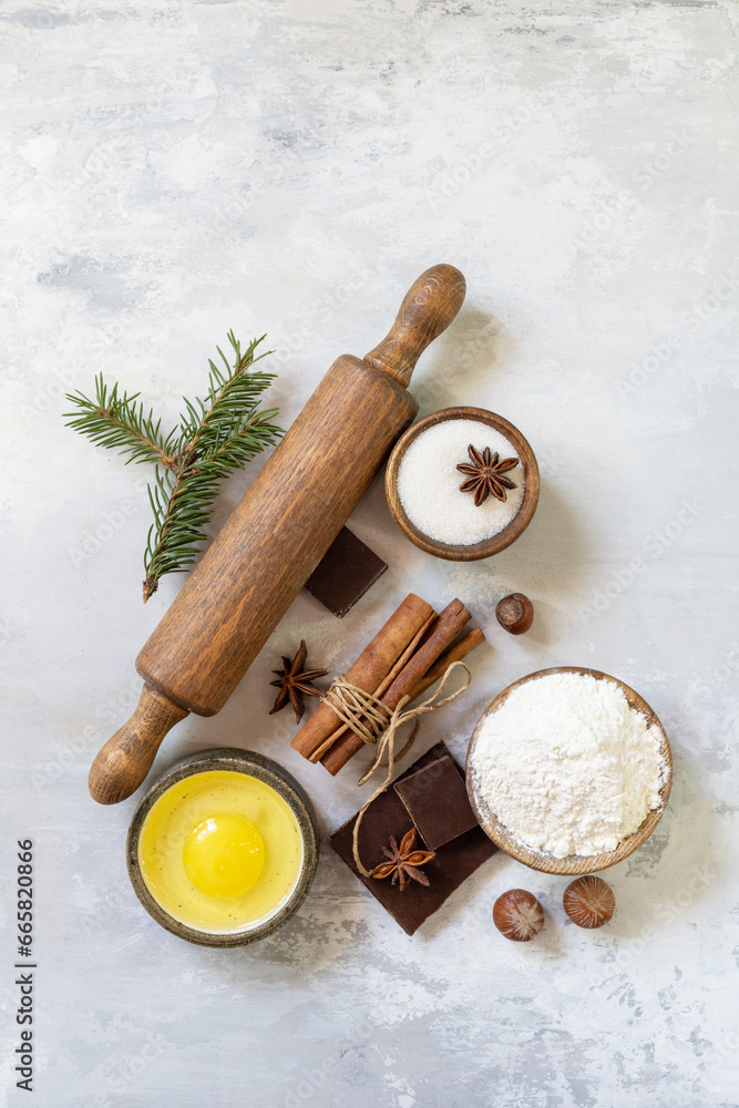 Baking background. Christmas and New Year background with baking ingredients, kitchen utensils and fir twigs. View from above.