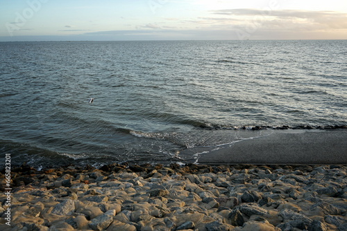 Küstenschutz mit Wellenbrecher am Deich im Herbst in Büsum im Kreis Dithmarschen an der Küste der Nordsee an der Nordsee in Nordfriesland in Schleswig-Holstein photo