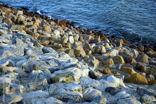 Küstenschutz mit Wellenbrecher am Deich im Herbst in Büsum im Kreis Dithmarschen an der Küste der Nordsee an der Nordsee in Nordfriesland in Schleswig-Holstein photo