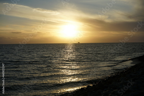 Küstenschutz mit Wellenbrecher am Deich im Herbst in Büsum im Kreis Dithmarschen bei Sonnenuntergang an der Küste der Nordsee an der Nordsee in Nordfriesland in Schleswig-Holstein photo