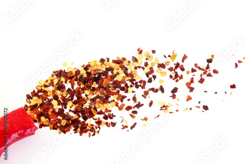 Fototapeta Naklejka Na Ścianę i Meble -  hot red chili pepper with chili flakes burst in white background as food background,top view with copy space