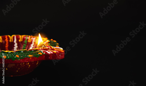 Diwali's warm embrace is felt through these radiant clay diya lamps, signifying prosperity and happiness, on a serene black background. Perfect for invitations, abstract art, and religious ceremonies.
