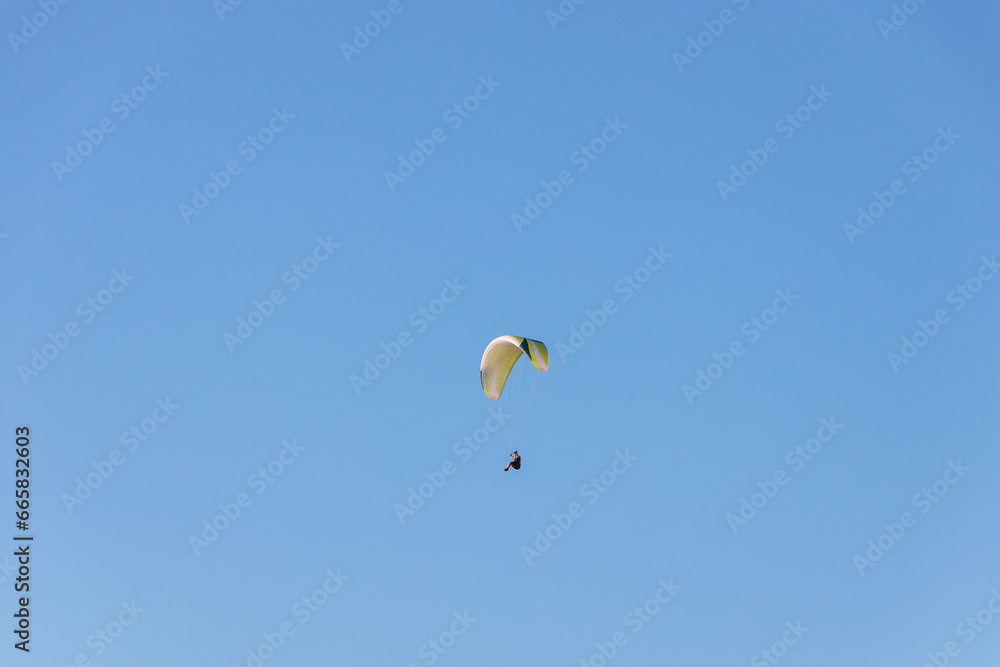Paraglider Soaring in a Blue Sky Paraglider Soaring in a Blue Sky