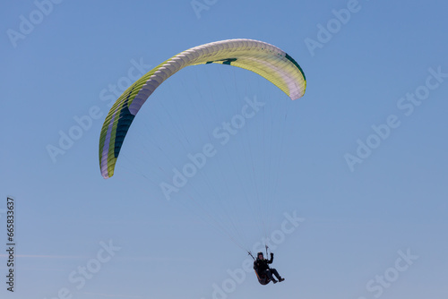 Paraglider Soaring in a Blue Sky