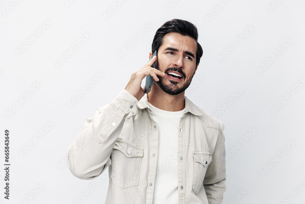 Closeup portrait man talking on the phone angry annoyance and quarrel on white isolated background, fashion style clothes, copy space, space for text Closeup portrait man talking on the phone angry annoyance and quarrel on white isolated background, fashion style clothes, copy space, space for text
