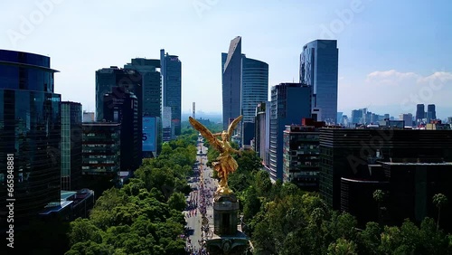 Aerial view from Mexico angel de la independencia monument in a festival dia de muertos parade, alebrijes art in reforma street