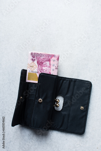 The new Nigerian 200 Naira note in a wallet, Nigeria's new currency photo