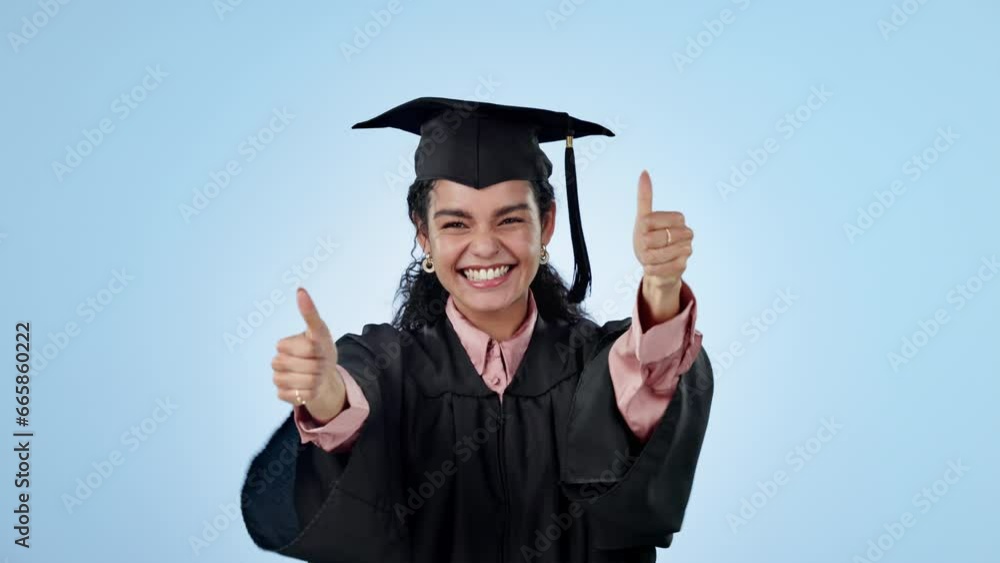 Graduation success, thumbs up or excited student in studio with education, college or university goal. Woman, hand sign or happy graduate with learning achievement or scholarship on blue background Graduation success, thumbs up or excited student in studio with education, college or university goal. Woman, hand sign or happy graduate with learning achievement or scholarship on blue background
