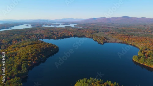 Mirror Lake shore at Lake Winnipesaukee aerial view with Ossipee Mountains at the background in fall in town of Wolfeboro, New Hampshire NH, USA.  photo