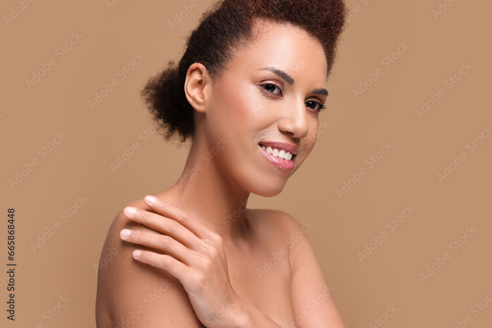 Portrait of beautiful young woman with glamorous makeup on light brown background Portrait of beautiful young woman with glamorous makeup on light brown background
