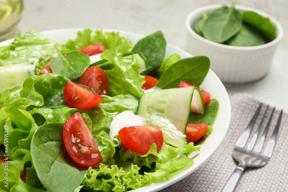 Delicious vegetable salad served on light grey table, closeup Delicious vegetable salad served on light grey table, closeup