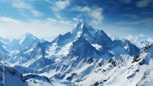 Snow-covered mountains reaching for the cold, blue sky 