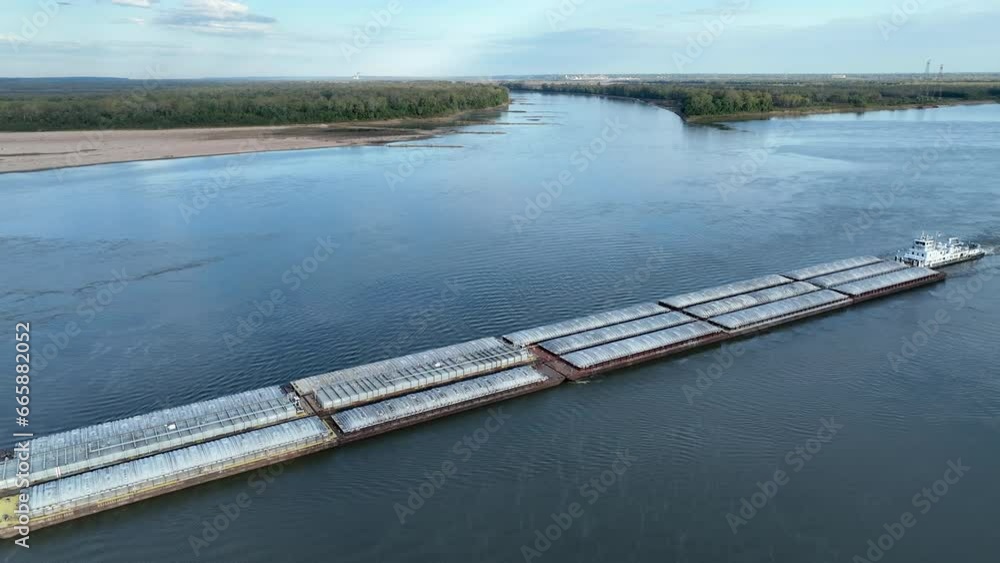 towboat with barges on the Mississippi River at confluence with the Missouri River below Alton, IL towboat with barges on the Mississippi River at confluence with the Missouri River below Alton, IL