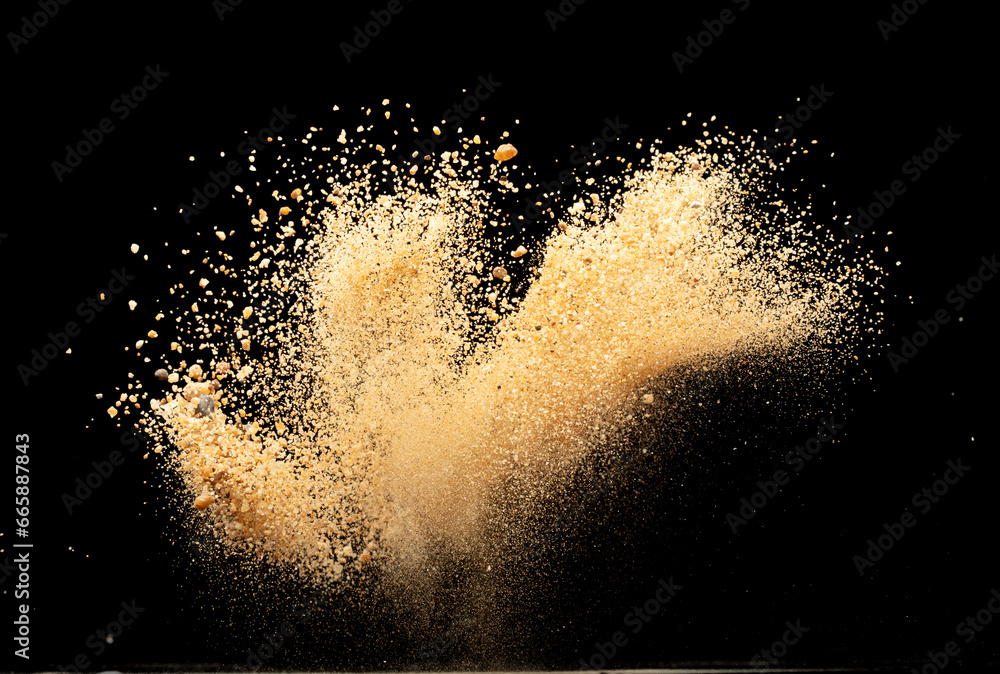 Obraz premium Big size Sand flying explosion, Golden grain wave explode. Abstract cloud fly. Yellow colored sand splash throwing in Air. Black background Isolated selective focus blur