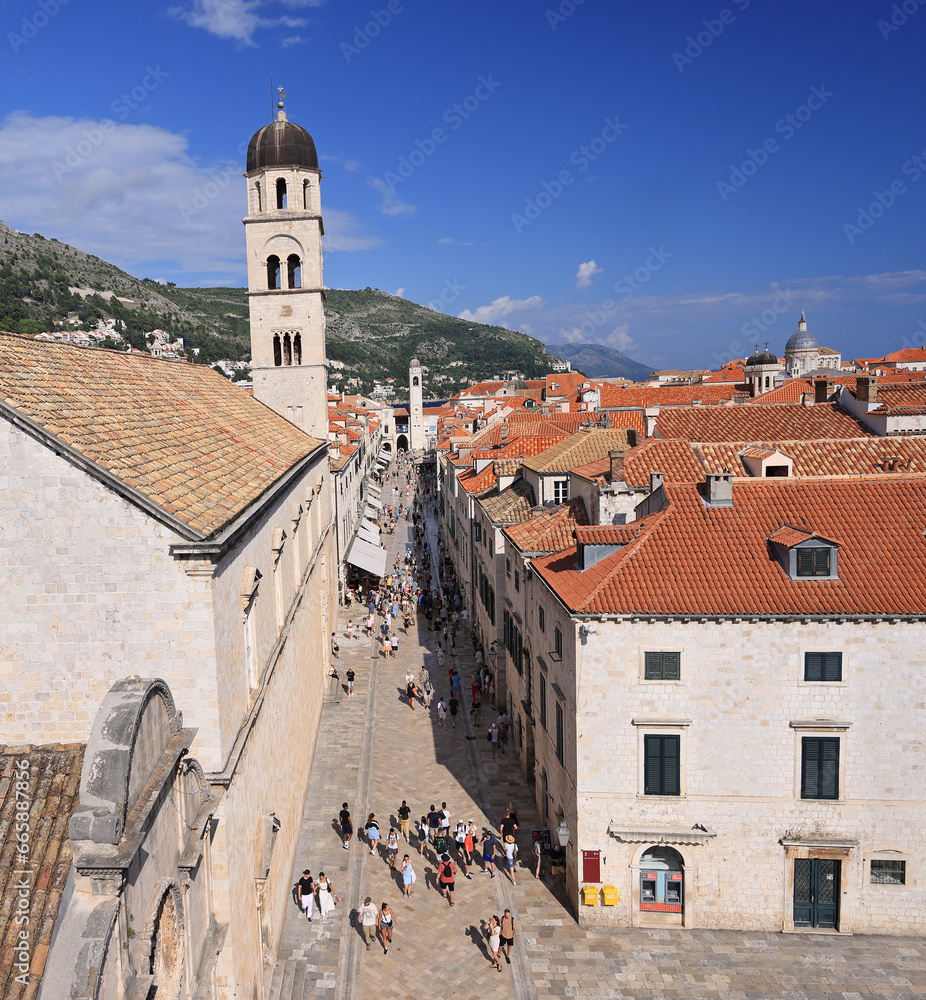 Tourists walking on ancient Stradun street in old city in Dubrovnik