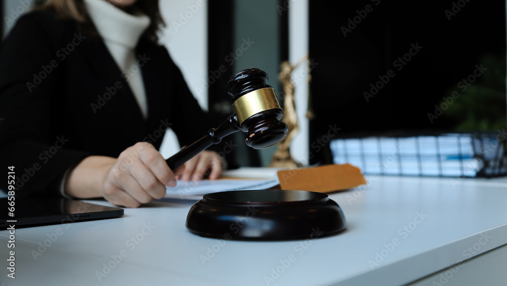 Judge gavel with Justice lawyers having team meeting at law firm in background. Concepts of law. Judge gavel with Justice lawyers having team meeting at law firm in background. Concepts of law.