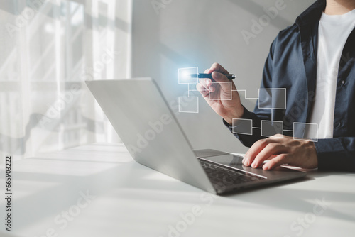 Person with hologram flowchart, businessman designing flowchart business workflow to systematically qualitatively, flowcharting to visualize the workflow of the program. Flowchart design concept. photo