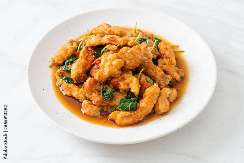 stir-fried fried fish with basil and chili in thai style stir-fried fried fish with basil and chili in thai style