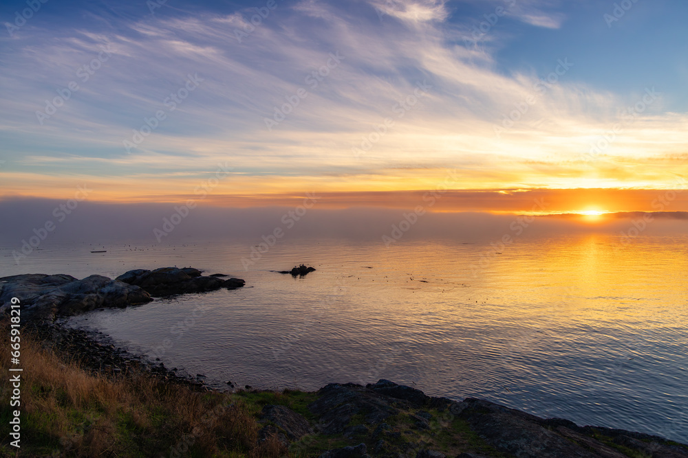 Rocky Shore on the Pacific Ocean Coast. Foggy Sunset. Victoria, Vancouver Island, BC, Canada. Rocky Shore on the Pacific Ocean Coast. Foggy Sunset. Victoria, Vancouver Island, BC, Canada.