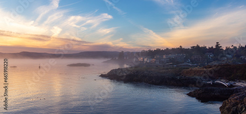 Rocky Shore on the Pacific Ocean Coast. Foggy Sunset. Victoria, Vancouver Island, BC, Canada.