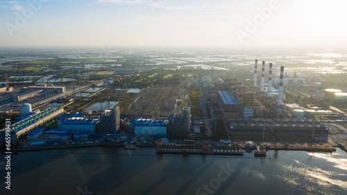 Aerial view Bang Pakong power plant of gas power plant, Thermal power plants and fuel oil, electrical power plant. energy concept, morning sky, container ship, freight transportation,