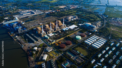 Aerial view Bang Pakong power plant of gas power plant, Thermal power plants and fuel oil, electrical power plant. energy concept, morning sky, container ship,