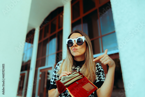 Rich Woman Pointing at her Wallet full of Cash. Funny lady bragging about her wealth and style
