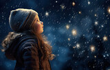 a young girl is looking up at the snow flakes in the winter
