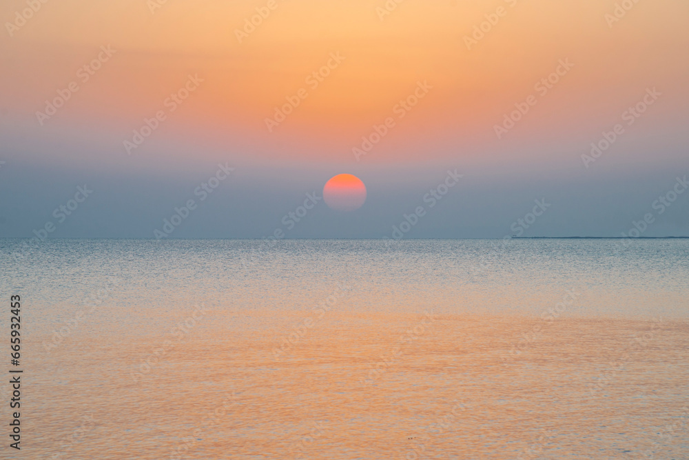 Landscape of sunrise, sun, sky and beach on the shores of the Red Sea