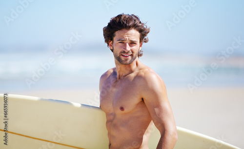 Beach portrait, surfing and fitness man on sports holiday, vacation or getaway for nature wellness, sea break or hobby. Surfboard, activity and surfer on tropical island paradise, coast or shore