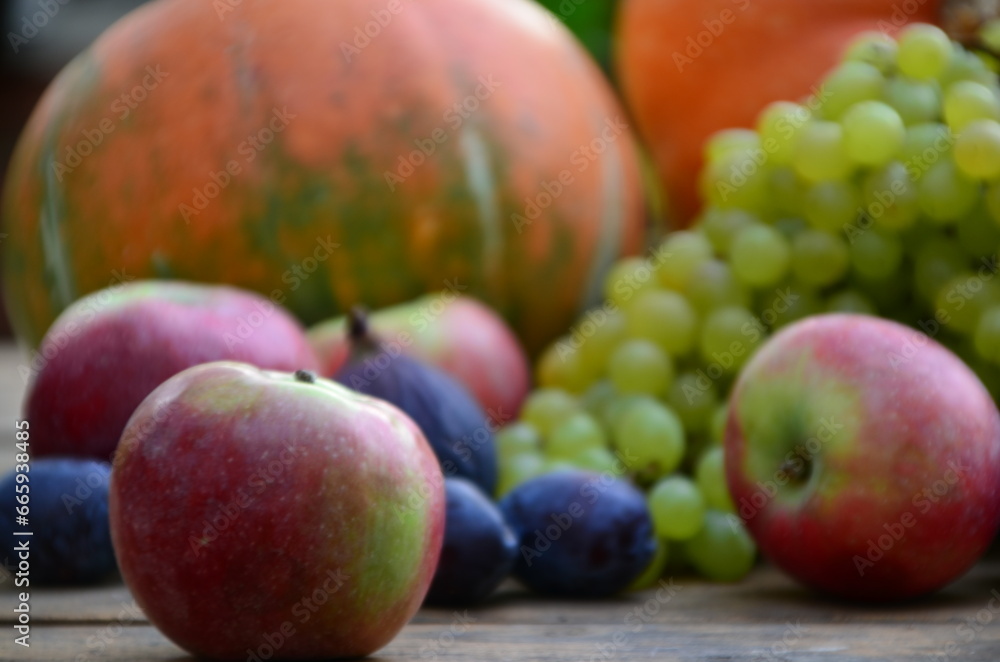 Assortment of fruits, grapes and nuts. Autumn seasonal harvest. pumpkin apples, red, yellow leaves. food still life with season fruits. Thanksgiving day, Halloween decoration fall design Assortment of fruits, grapes and nuts. Autumn seasonal harvest. pumpkin apples, red, yellow leaves. food still life with season fruits. Thanksgiving day, Halloween decoration fall design