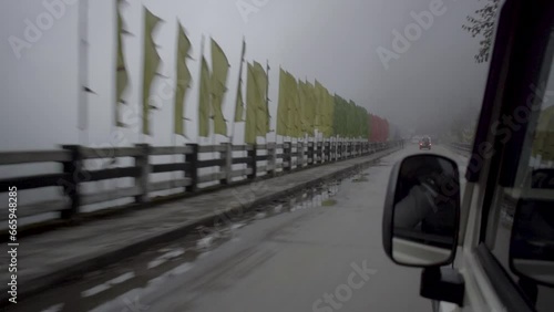 Car on a cloudy bridge in sikkim photo