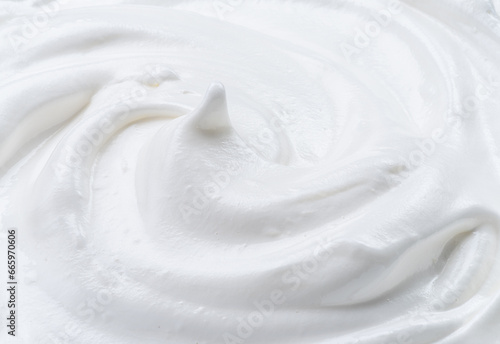 Creamy pic and waves in yoghurt or cream surface. Top view.
