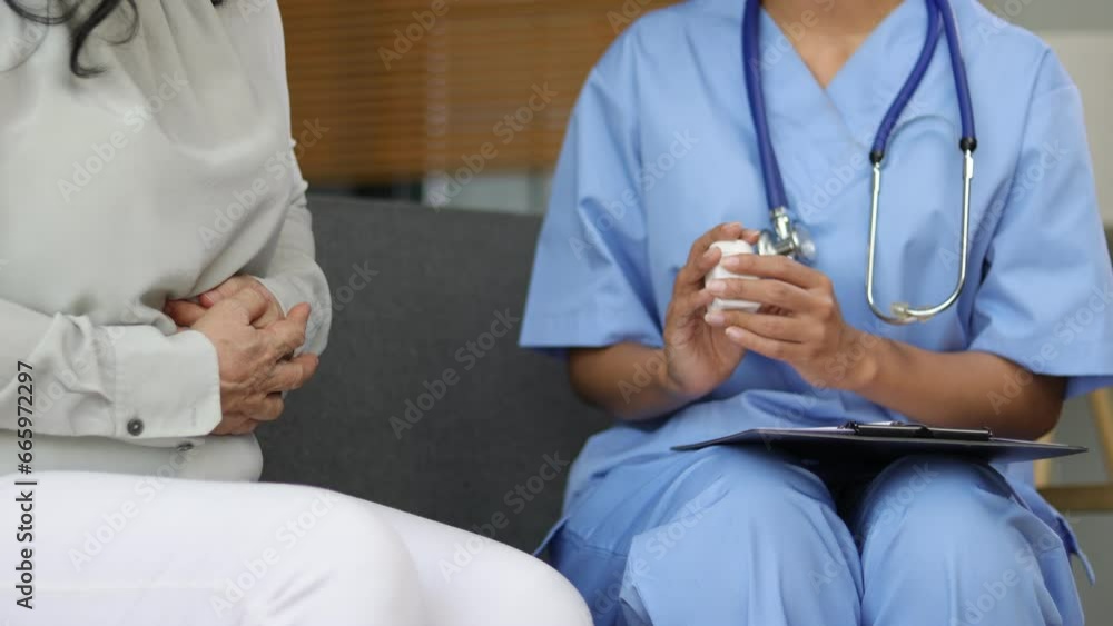 Doctor is diagnosing and giving medicine to a patient with diarrhea. Senior woman with abdominal pain and diarrhea is talking with a doctor in an examination room at a hospital. Doctor is diagnosing and giving medicine to a patient with diarrhea. Senior woman with abdominal pain and diarrhea is talking with a doctor in an examination room at a hospital.