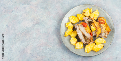 Fotografija Pork meat baked with pineapple, space for text.