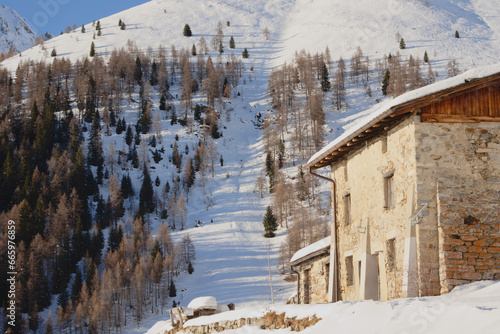 Snow covered farmhouse in the Italian Alps photo