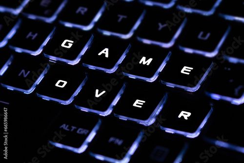 Gamer keyboard with game over message.