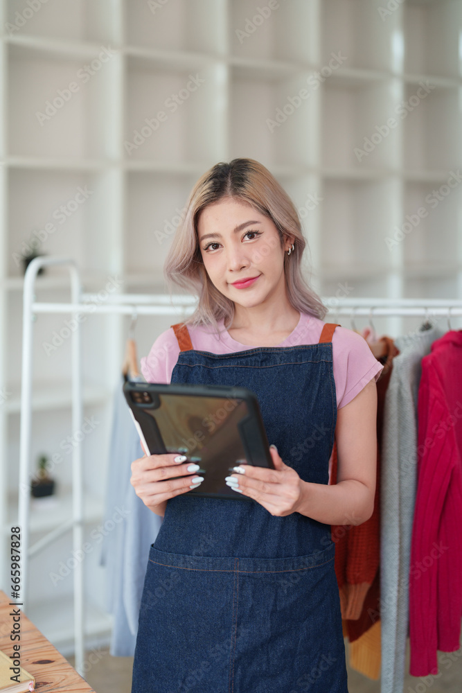 Portrait Of Asian Female Owner Of Fashion Store Clothing Store successful happy smile at small business, sme or ecommerce concepts Portrait Of Asian Female Owner Of Fashion Store Clothing Store successful happy smile at small business, sme or ecommerce concepts